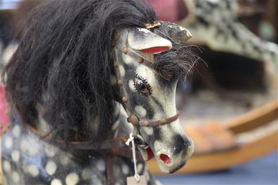 A black and grey painted rocking horse, overall length 6ft 11in.